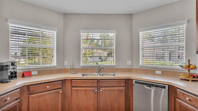 kitchen with dishwasher, a sink, healthy amount of natural light, and light countertops