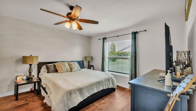bedroom with wood finished floors, baseboards, and ceiling fan