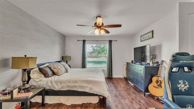 bedroom featuring dark wood finished floors and ceiling fan
