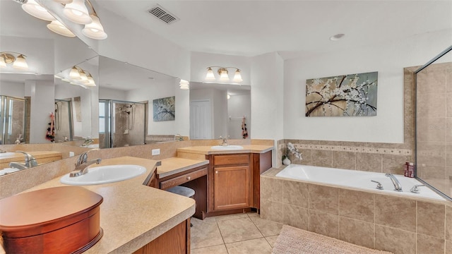 full bathroom featuring tile patterned floors, a shower stall, a bath, and vanity