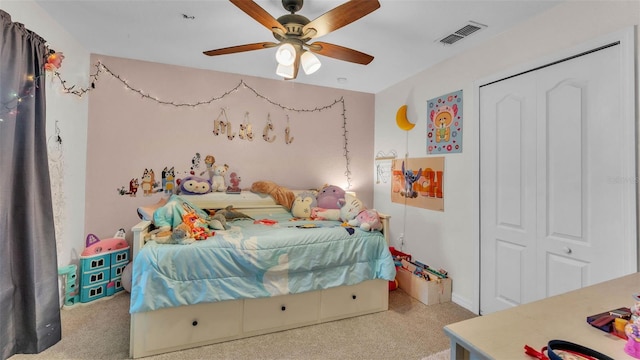 carpeted bedroom with a closet and a ceiling fan