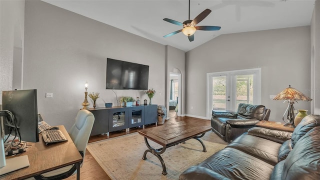 living area with wood finished floors, ceiling fan, and high vaulted ceiling