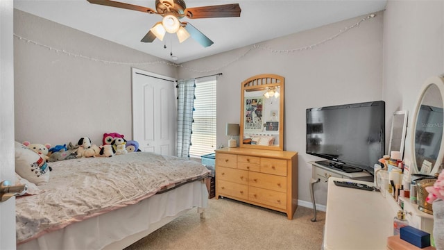 bedroom featuring light carpet, a closet, and ceiling fan