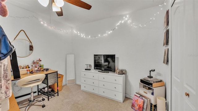 office space featuring a ceiling fan and light carpet