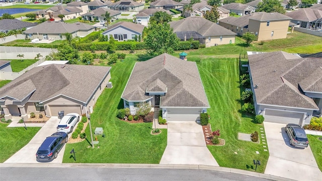 aerial perspective of suburban area with a nearby body of water