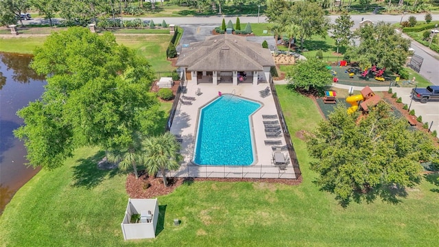 aerial view of property and surrounding area with a pool area and a nearby body of water