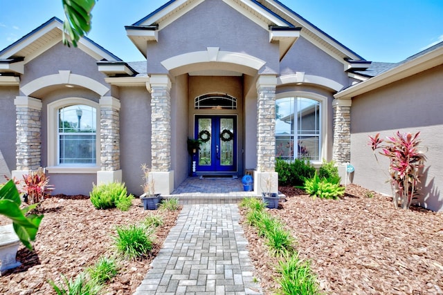 2032 Indian Sky Cir, Lakeland, FL 33813 - doorway to property featuring french doors, stone siding, and stucco siding