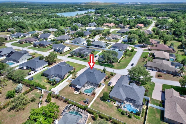 2032 Indian Sky Cir, Lakeland, FL 33813 - aerial view of property's location with a nearby body of water, a forest, and nearby suburban area