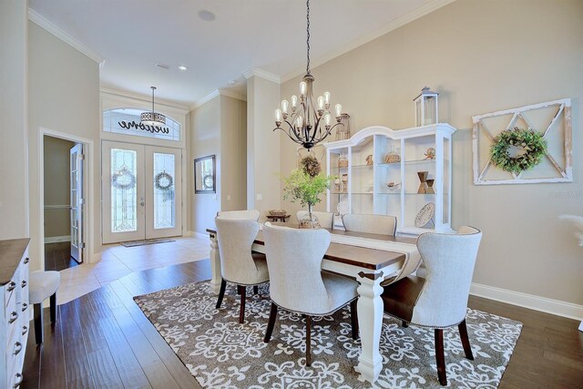 2032 Indian Sky Cir, Lakeland, FL 33813 - dining space featuring french doors, baseboards, dark wood-type flooring, a chandelier, and ornamental molding