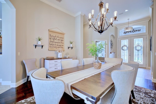 2032 Indian Sky Cir, Lakeland, FL 33813 - dining area featuring arched walkways, wood finished floors, a chandelier, and ornamental molding