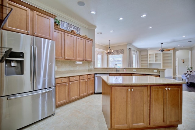 2032 Indian Sky Cir, Lakeland, FL 33813 - kitchen with stainless steel appliances, ornamental molding, a kitchen island, recessed lighting, and light countertops