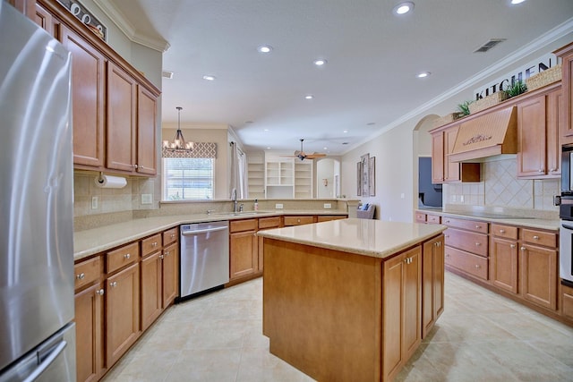 2032 Indian Sky Cir, Lakeland, FL 33813 - kitchen featuring appliances with stainless steel finishes, recessed lighting, ornamental molding, a peninsula, and premium range hood
