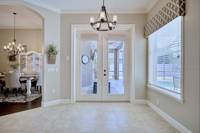 2032 Indian Sky Cir, Lakeland, FL 33813 - entryway featuring a chandelier, ornamental molding, arched walkways, and baseboards