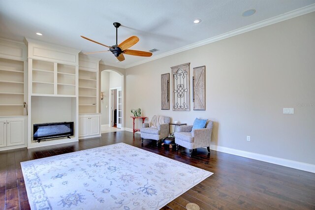2032 Indian Sky Cir, Lakeland, FL 33813 - sitting room with crown molding, dark wood-type flooring, arched walkways, baseboards, and ceiling fan