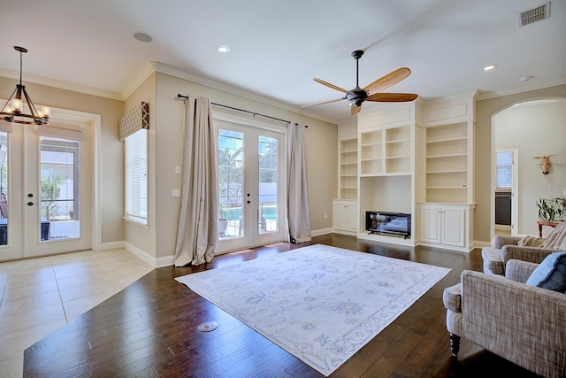2032 Indian Sky Cir, Lakeland, FL 33813 - living area with french doors, ornamental molding, arched walkways, ceiling fan, and wood-type flooring