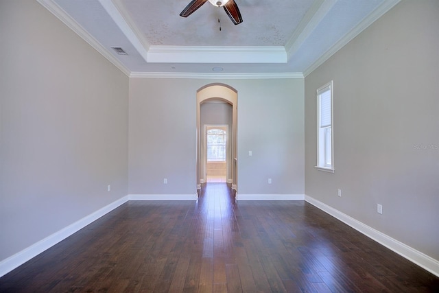 2032 Indian Sky Cir, Lakeland, FL 33813 - empty room with a tray ceiling, arched walkways, ceiling fan, dark wood finished floors, and baseboards