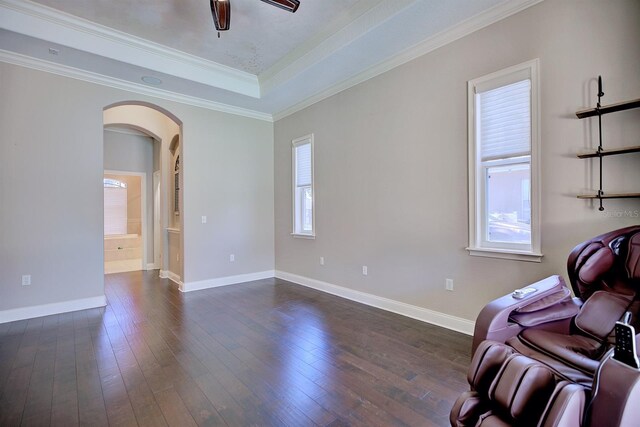 2032 Indian Sky Cir, Lakeland, FL 33813 - unfurnished room with arched walkways, dark wood-style floors, baseboards, crown molding, and ceiling fan