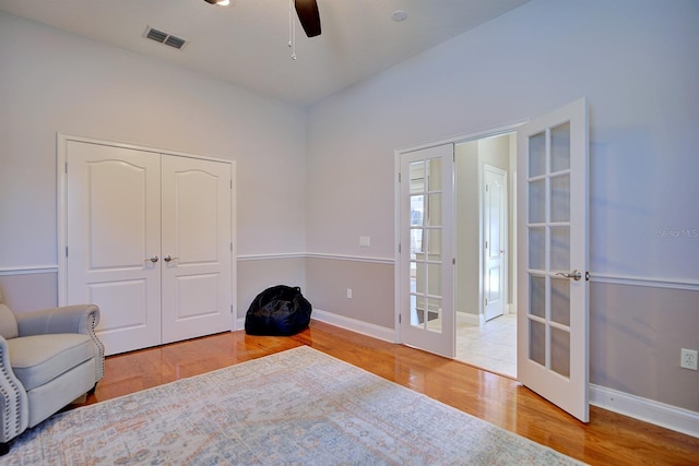 2032 Indian Sky Cir, Lakeland, FL 33813 - living area with french doors, a ceiling fan, wood finished floors, and baseboards