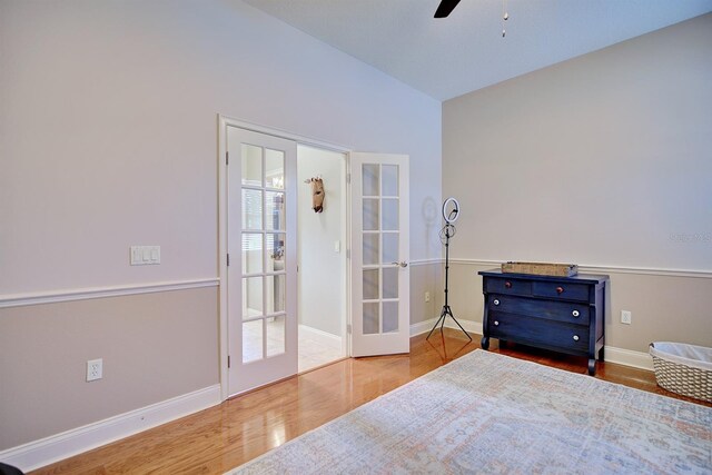 2032 Indian Sky Cir, Lakeland, FL 33813 - bedroom with wood finished floors, french doors, baseboards, and a ceiling fan