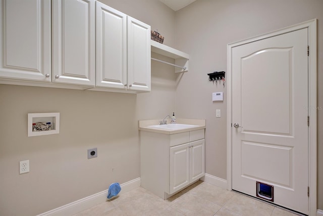 2032 Indian Sky Cir, Lakeland, FL 33813 - laundry room with electric dryer hookup, cabinet space, baseboards, light tile patterned flooring, and washer hookup