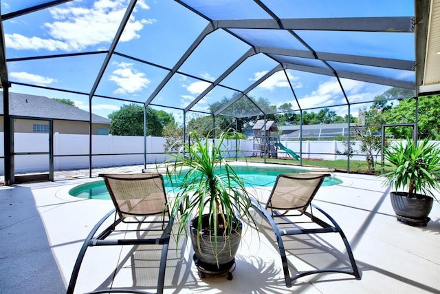 2032 Indian Sky Cir, Lakeland, FL 33813 - view of patio featuring a fenced backyard, a lanai, and a playground