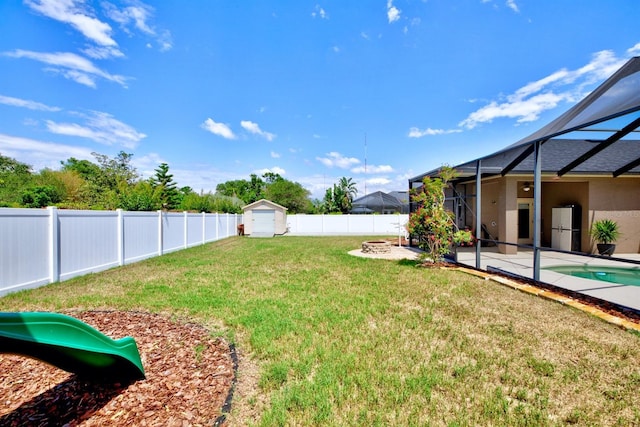 2032 Indian Sky Cir, Lakeland, FL 33813 - view of yard with a playground, a patio area, a storage unit, glass enclosure, and an outdoor structure