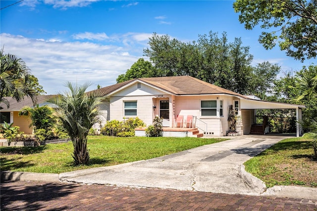 2710 Fairmount Ave, Lakeland, FL 33803 - view of front facade with driveway, a front lawn, and a carport