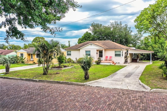 2710 Fairmount Ave, Lakeland, FL 33803 - view of front of property featuring driveway, a front lawn, an attached carport, and stucco siding