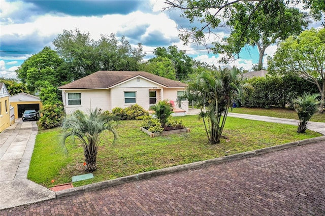 2710 Fairmount Ave, Lakeland, FL 33803 - ranch-style home with a front yard, concrete driveway, and an outbuilding