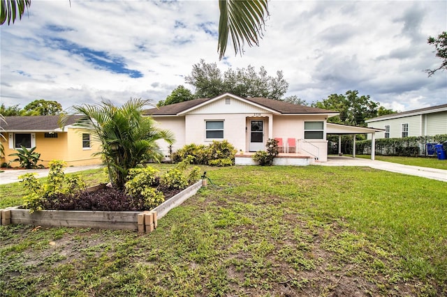 2710 Fairmount Ave, Lakeland, FL 33803 - view of front facade featuring driveway, a carport, and a front lawn