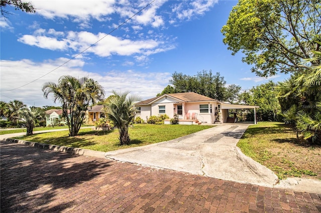 2710 Fairmount Ave, Lakeland, FL 33803 - ranch-style home with concrete driveway, a front lawn, and an attached carport