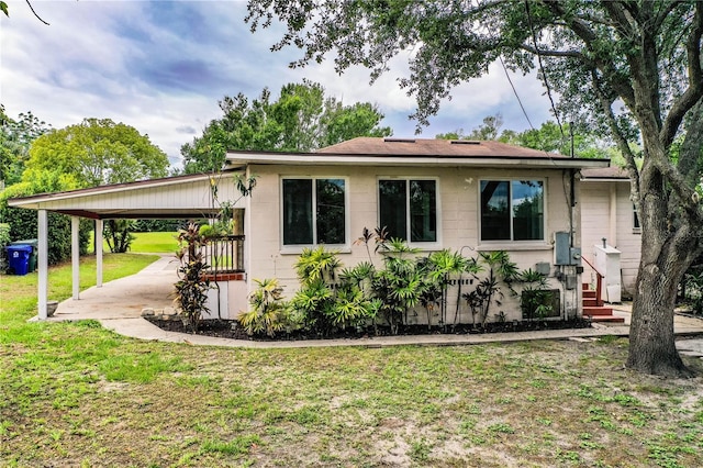 2710 Fairmount Ave, Lakeland, FL 33803 - view of front of home with a carport, a front yard, concrete block siding, and a patio area