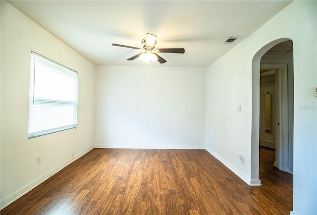 2710 Fairmount Ave, Lakeland, FL 33803 - spare room featuring arched walkways, wood finished floors, ceiling fan, and baseboards