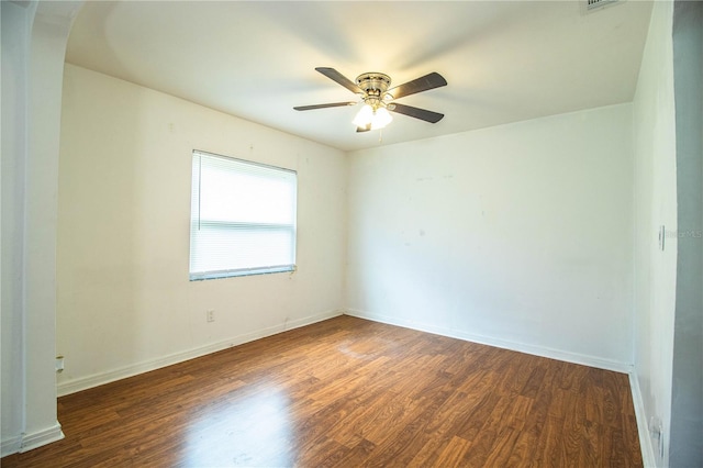 2710 Fairmount Ave, Lakeland, FL 33803 - unfurnished room with wood finished floors, arched walkways, a ceiling fan, and baseboards