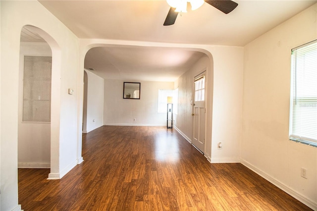 2710 Fairmount Ave, Lakeland, FL 33803 - empty room featuring a ceiling fan, dark wood-style floors, baseboards, and arched walkways