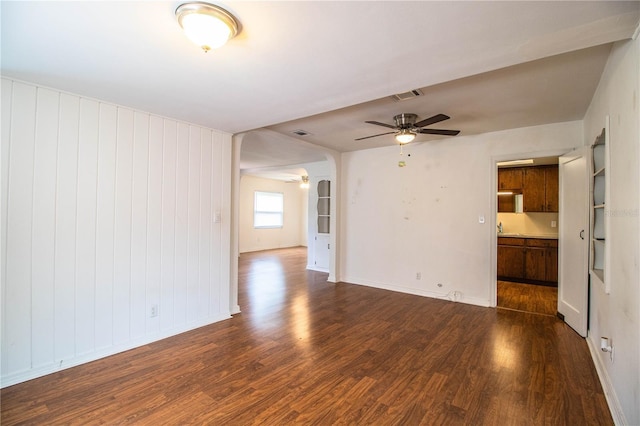 2710 Fairmount Ave, Lakeland, FL 33803 - unfurnished living room featuring a ceiling fan, dark wood-style flooring, and baseboards