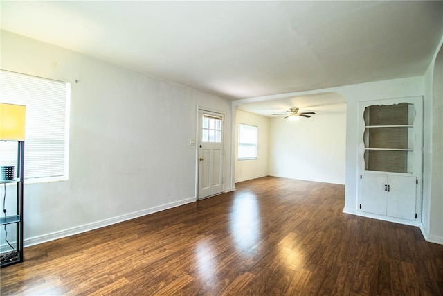 2710 Fairmount Ave, Lakeland, FL 33803 - unfurnished living room with ceiling fan, wood finished floors, baseboards, and arched walkways