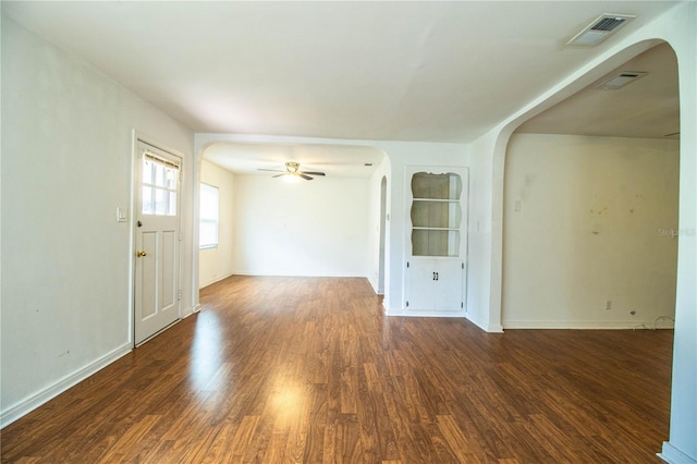 2710 Fairmount Ave, Lakeland, FL 33803 - empty room featuring arched walkways, wood finished floors, a ceiling fan, and baseboards