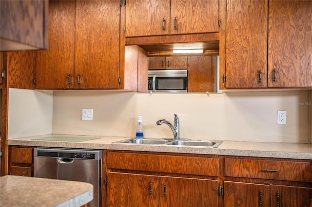 2710 Fairmount Ave, Lakeland, FL 33803 - kitchen featuring appliances with stainless steel finishes, a sink, light countertops, and brown cabinets