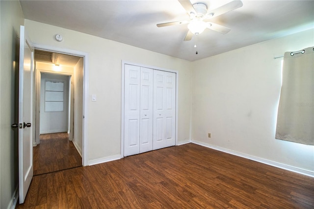 2710 Fairmount Ave, Lakeland, FL 33803 - unfurnished bedroom with dark wood-style floors, baseboards, a closet, and a ceiling fan