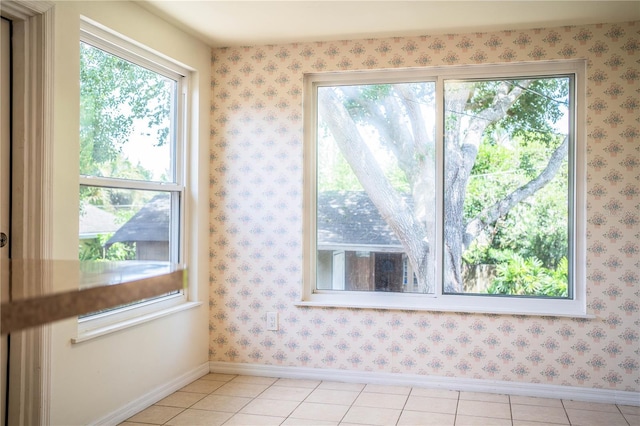 2710 Fairmount Ave, Lakeland, FL 33803 - empty room with plenty of natural light, baseboards, and light tile patterned floors