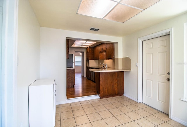 2710 Fairmount Ave, Lakeland, FL 33803 - kitchen featuring light countertops, light tile patterned flooring, baseboards, and a sink