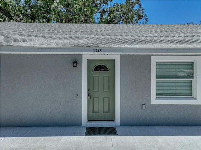 1415 Southern Ave, Lakeland, FL 33803 - entrance to property featuring a shingled roof and stucco siding