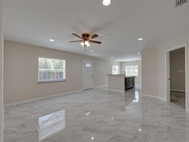 1415 Southern Ave, Lakeland, FL 33803 - entryway with light marble finish floors, ceiling fan, recessed lighting, baseboards, and a textured ceiling