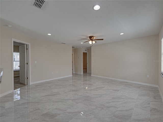1415 Southern Ave, Lakeland, FL 33803 - empty room featuring light marble finish floors, ceiling fan, recessed lighting, and baseboards