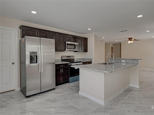 1415 Southern Ave, Lakeland, FL 33803 - kitchen with stainless steel appliances, a sink, light marble finish floors, a center island with sink, and recessed lighting