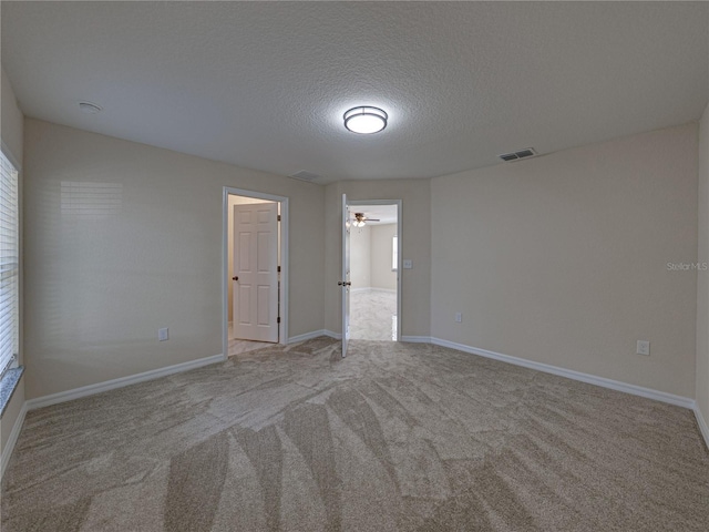 1415 Southern Ave, Lakeland, FL 33803 - carpeted empty room with a textured ceiling, a ceiling fan, and baseboards