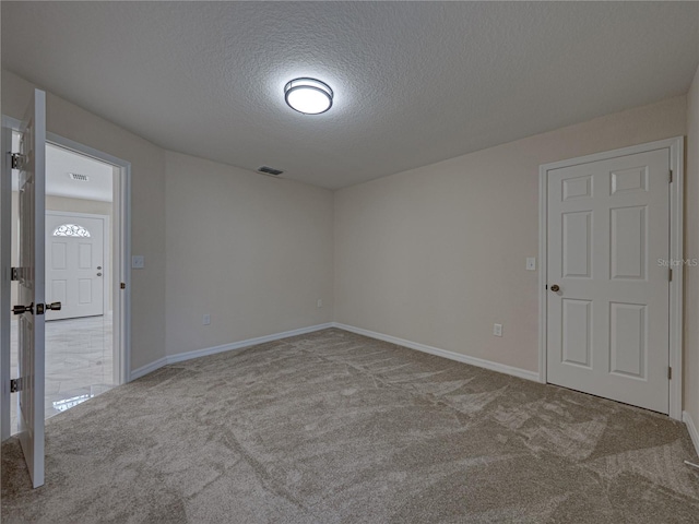 1415 Southern Ave, Lakeland, FL 33803 - spare room with a textured ceiling, carpet flooring, and baseboards