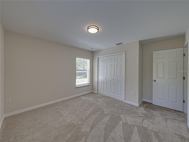 1415 Southern Ave, Lakeland, FL 33803 - unfurnished bedroom featuring carpet floors, a closet, and baseboards