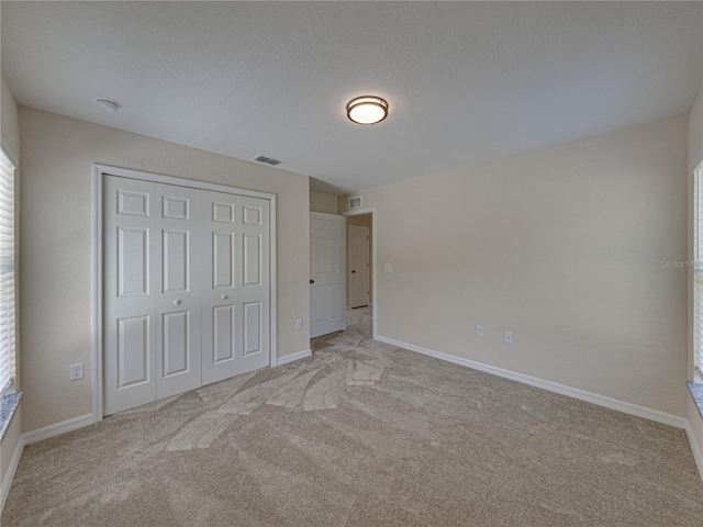 1415 Southern Ave, Lakeland, FL 33803 - unfurnished bedroom featuring carpet floors, a closet, and baseboards